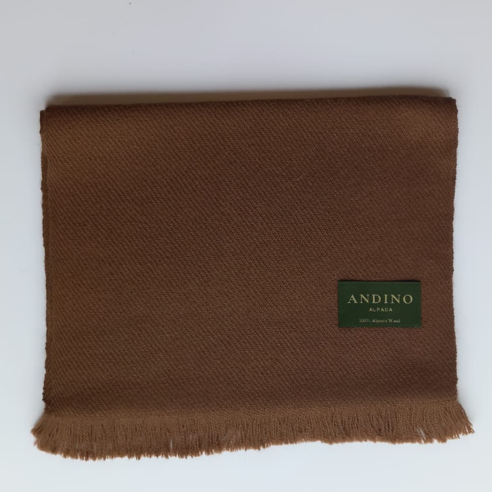 Brown large alpaca wool scarf shawl folded on white background with Andino Alpaca logo print.