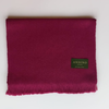 Burgundy large alpaca wool scarf shawl folded and slightly opened on white background with Andino Alpaca logo print.
