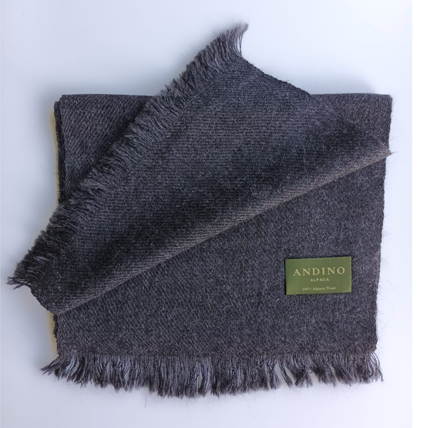 Dark grey large alpaca wool scarf shawl folded on white background with Andino Alpaca logo print.