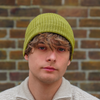 Olive Green alpaca wool beanie hat from the side on a white background