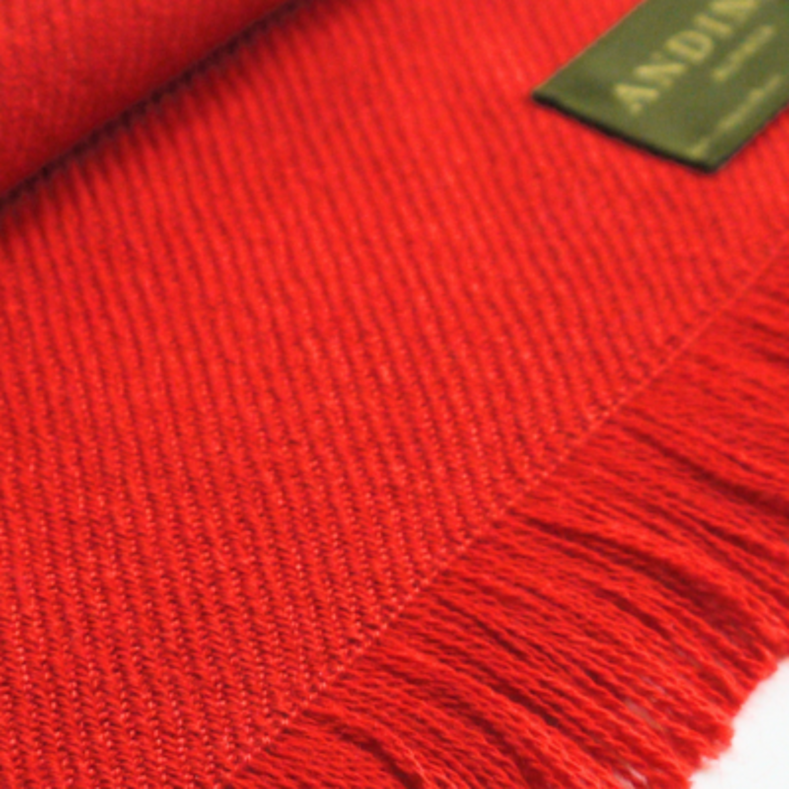 Zoomed in red alpaca wool scarf on a white background