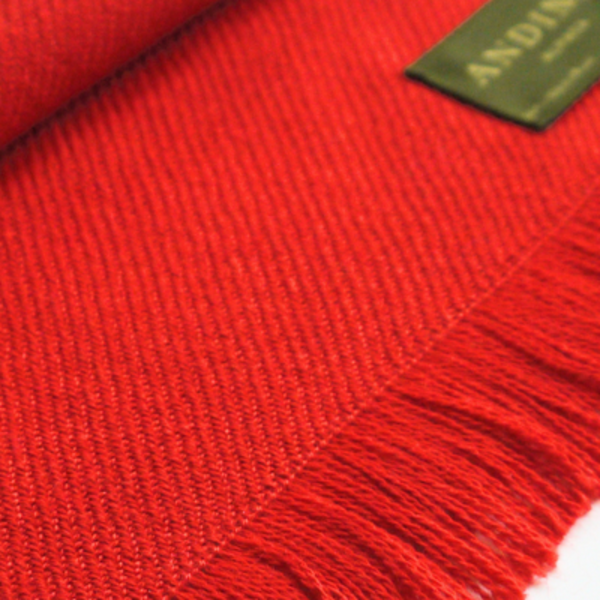 Zoomed in red alpaca wool scarf on a white background